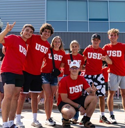A group of students posing and smiling on move in day.