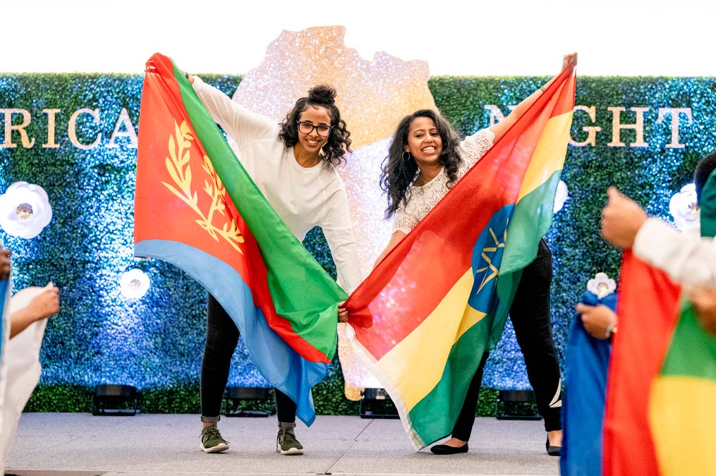 Students Holding Flags at African Night Event
