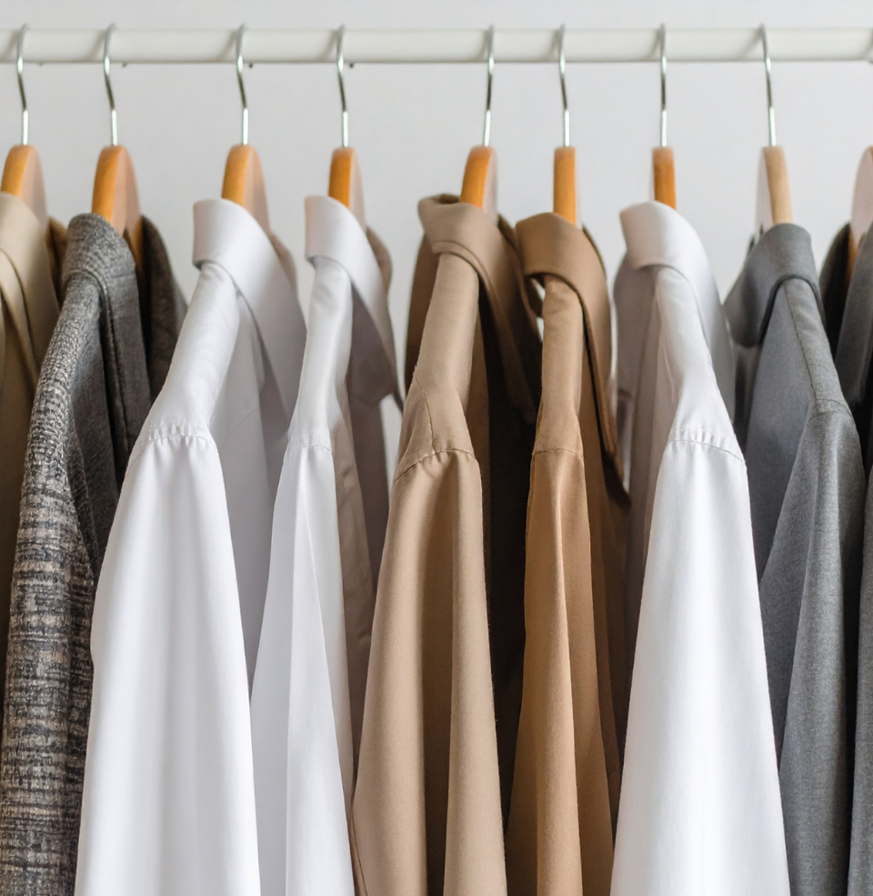 photo of professional blazers and button ups on a clothing rack