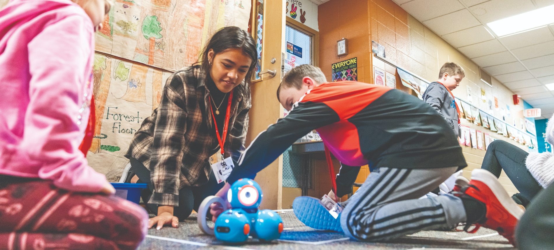 Young children playing with toys in a classroom.