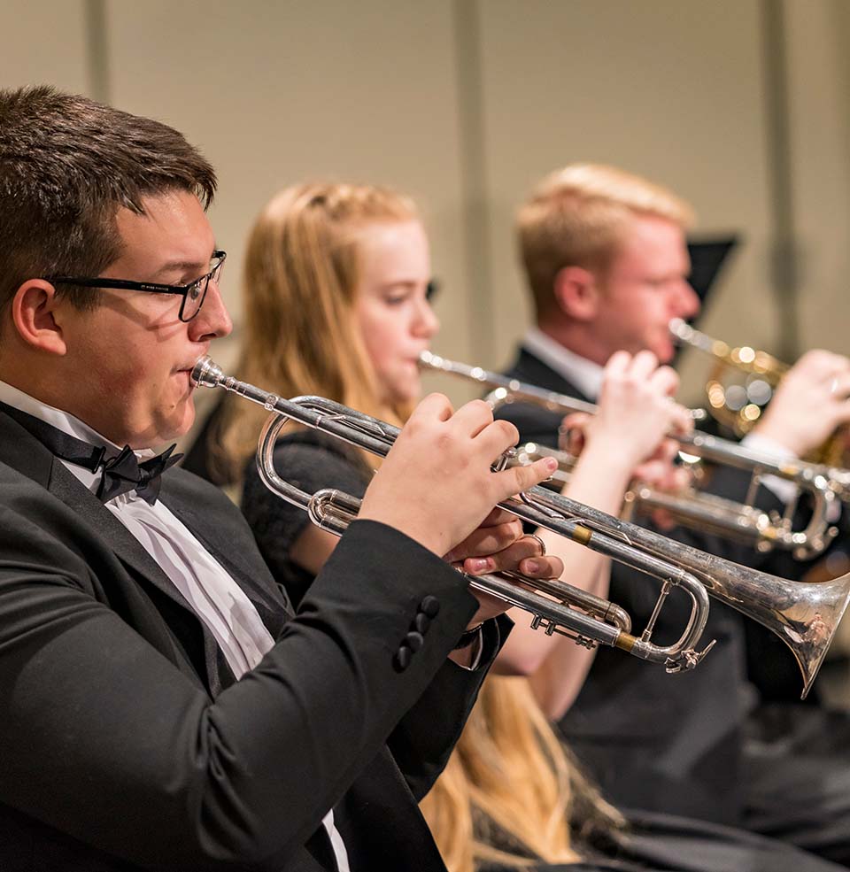 USD Symphonic Band students playing the trumpet.