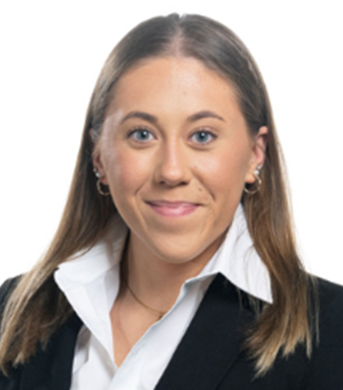 Headshot of Grace Espicha. Grace is smiling and has straight brown, collarbone length hair with a white dress shirt and black blazer. 
