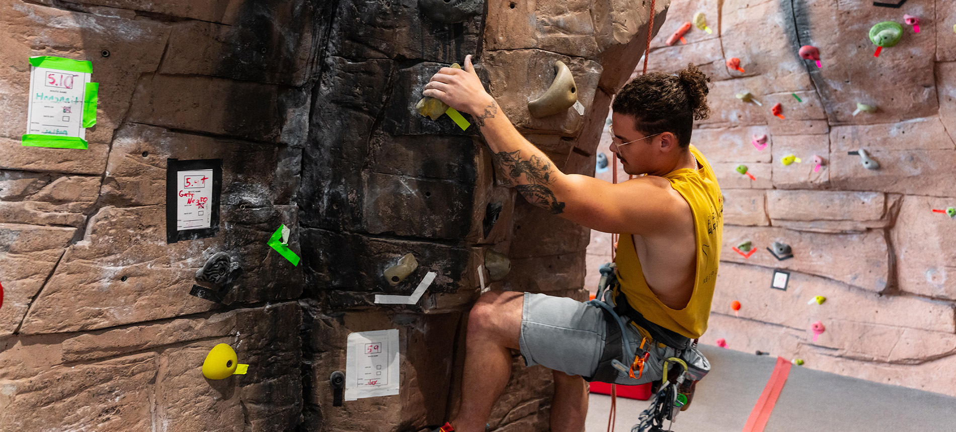 person climbing an indoor climbing wall on USDs campus 