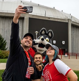 Students taking a selfie with Charlie Coyote