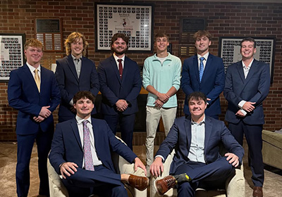 Beta Theta Pi group photo in front of their fraternity house.