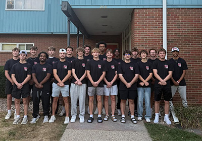 Tau Kappa Epsilon group photo in front of fraternity house. 