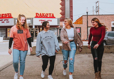 Sorority girls walking and laughing in downtown Vermillion.