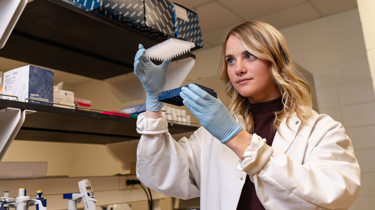 Brylie Hartwig examines a sample in her research project
