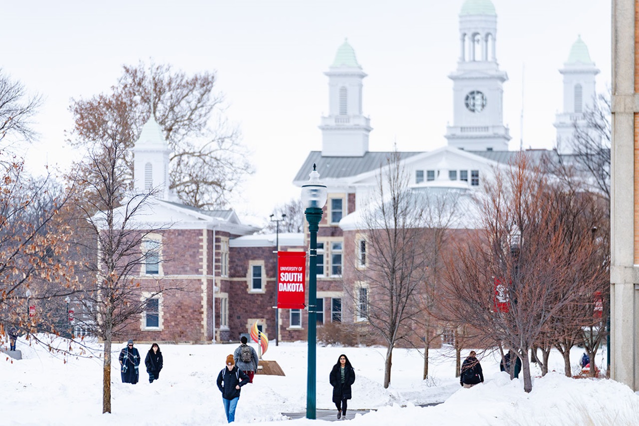 USD students walk across the snowy campus.
