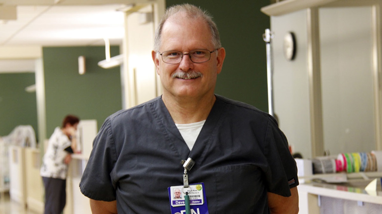 Dave Hobler, wearing his nurse's uniform and in the hallway of a hospital.  Dave Hobler, wearing his nurse's uniform and in the hallway of a hospital.