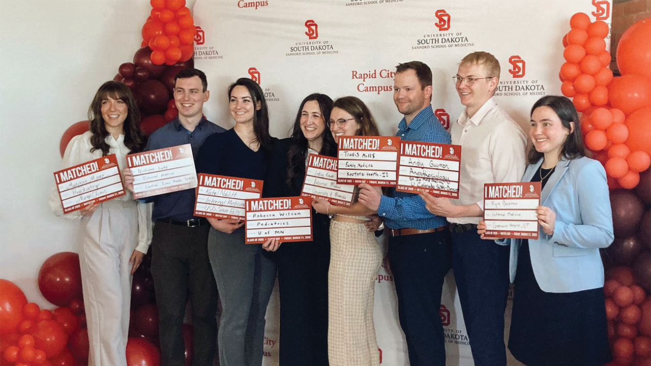 SSOM students pose with their match cards on match day.