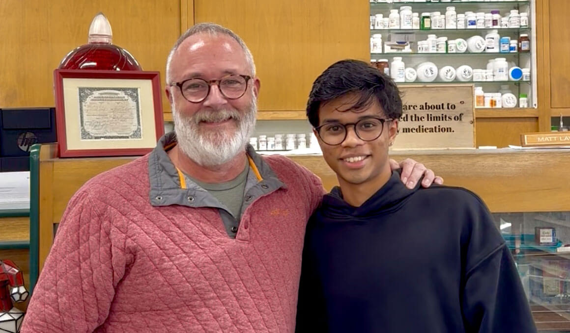 Matt Lavin, owner of Davis Pharmacy, and Shivansh Rastogi are posing together for a photo, smiling at the camera.