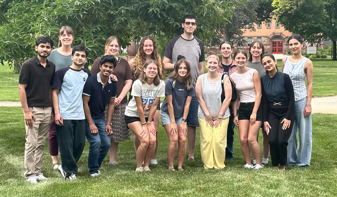 Members of the UDiscover summer research scholars stand and pose for a picture on the USD campus.