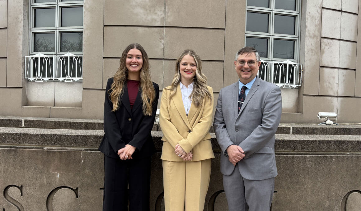 USD Law students, including Travis Letellier, Mayson Coyle and Julianne Severson, stand in front of a building posing for a photo while at the Judicial Clerkship Opinion Writing Conference in Washington, D.C.