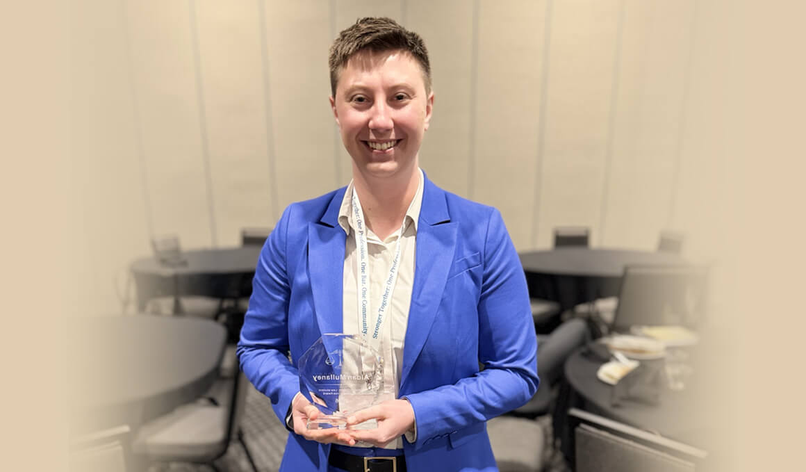 Aidan Mullaney, J.D., a 2026 University of South Dakota Knudson School of Law graduate, holds her William F. Day Jr. Law Student Pro Bono Award at the South Dakota State Bar Convention.  