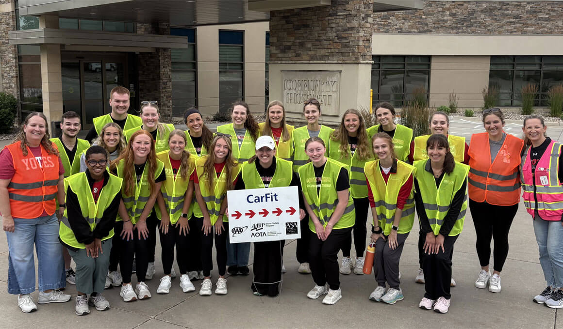 USD occupational therapy students pose for a group picture as they host a CarFit event.