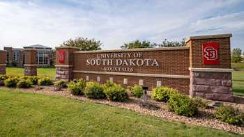 The USD – Sioux Falls sign at the entrance of the Sioux Falls campus.