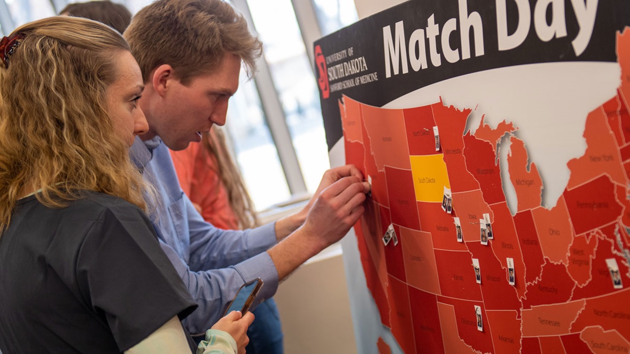 Two medical students put their pins in the map, showing where they were matched. Two medical students put their pins in the map, showing where they were matched.