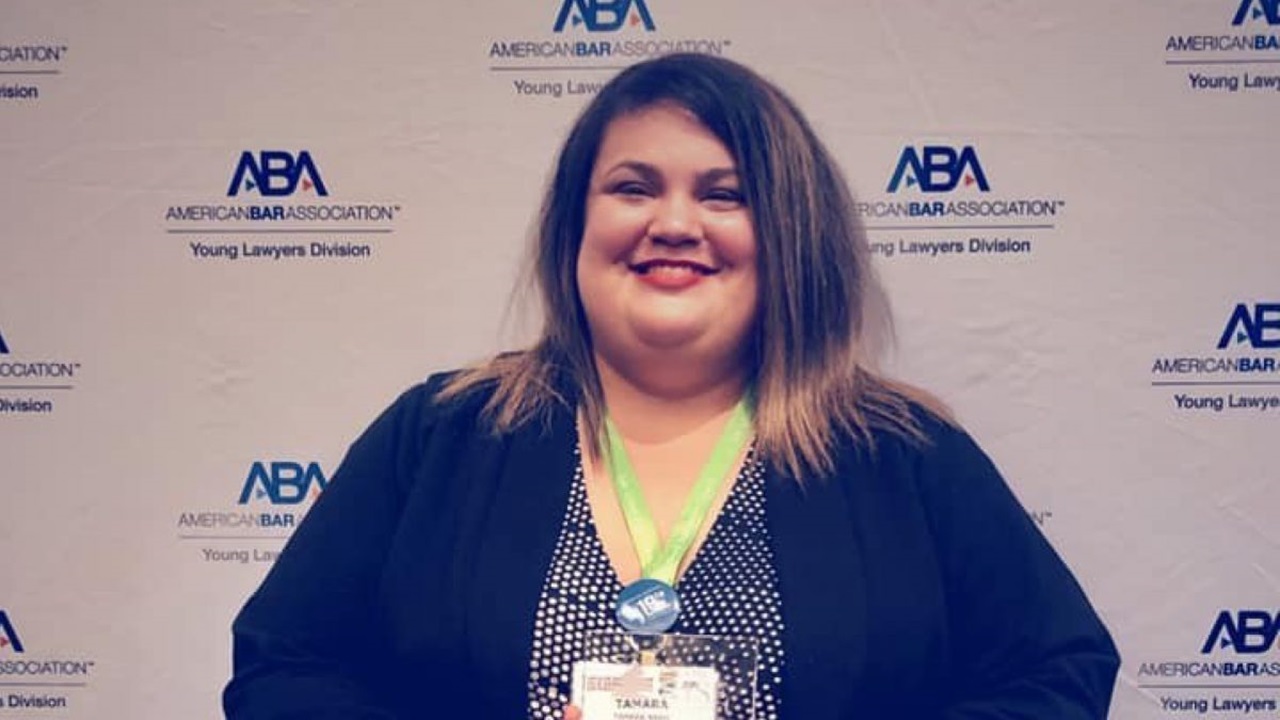 A photo of Tamara Nash in front of an American Bar Association background.