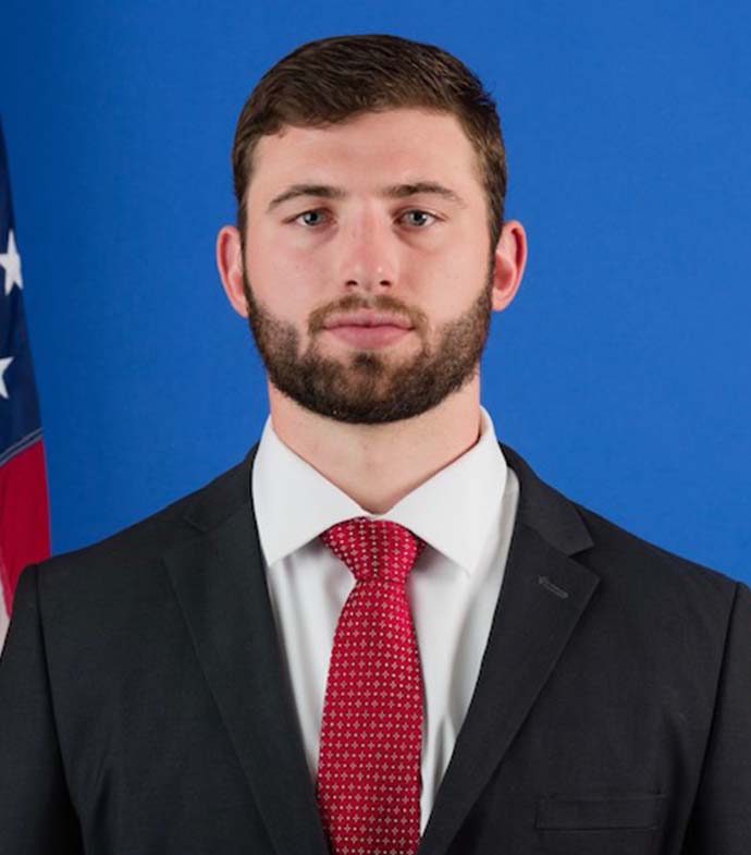 Success story Turner Blasius posing for the camera in a suit and tie.