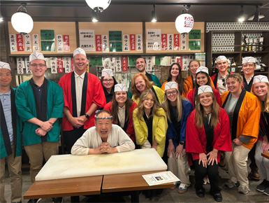 Students on the Global Immersion trip pose for a group photo with a chef.