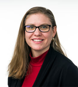 Lindsey Jorgensen, Ph.D., Au.D., looks toward the camera and smiles for her professional photo.