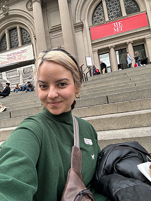 Outside the MET in NYC, a USD art student takes a picture.