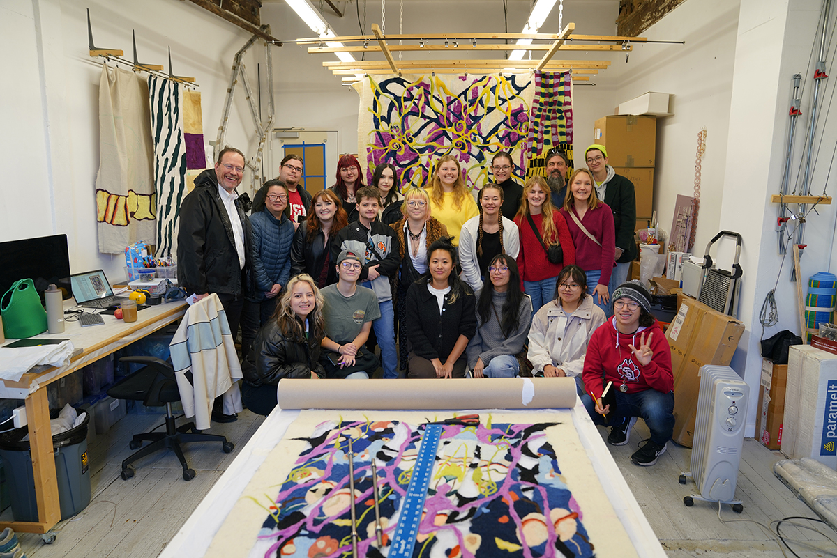 Art students take a group photo with a NYC artist.