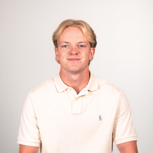 Connor Drahota, second year law student, poses for his headshot wearing a white collared shirt.