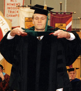 Dr. Dvoracek's medical school graduation. He is dressed in black regalia.