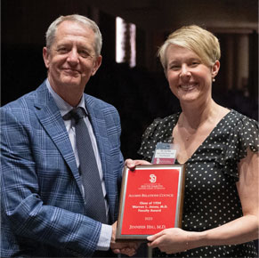 Jennifer Hsu with Tim Ridgway smiling for photo while holding award and shaking hands