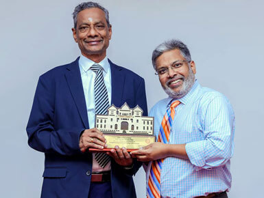 Dr. Thambi accepts an award from the University of Jaffna in congratulations of his appointment as president of the International College of Surgeons.