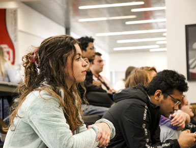 USD students listen to a professor in a classroom