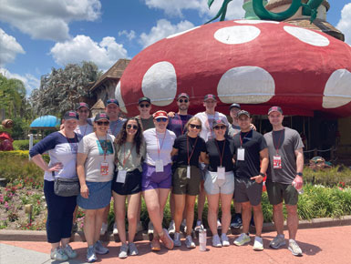 USD students pose for a photo on their Legacy Trip with a sunny sky.